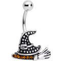 Close up view of a Halloween-themed witch hat and broom belly ring with yellow crystals
