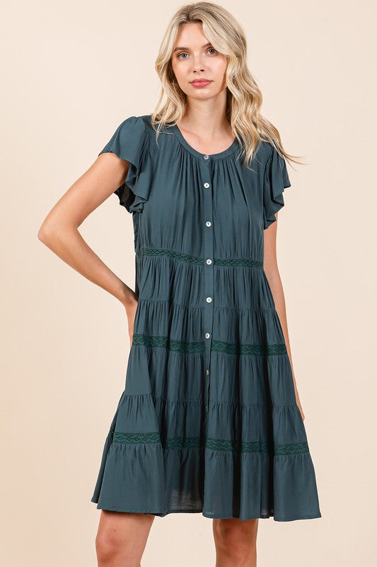 Romantic teal cotton dress with lace details and ruffled tiers