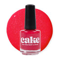 Sassy Senorita red nail polish bottle by CAKE, a long-wearing, strengthening formula.