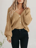 Model wearing a charcoal grey button-up ribbed knit long sleeve cardigan