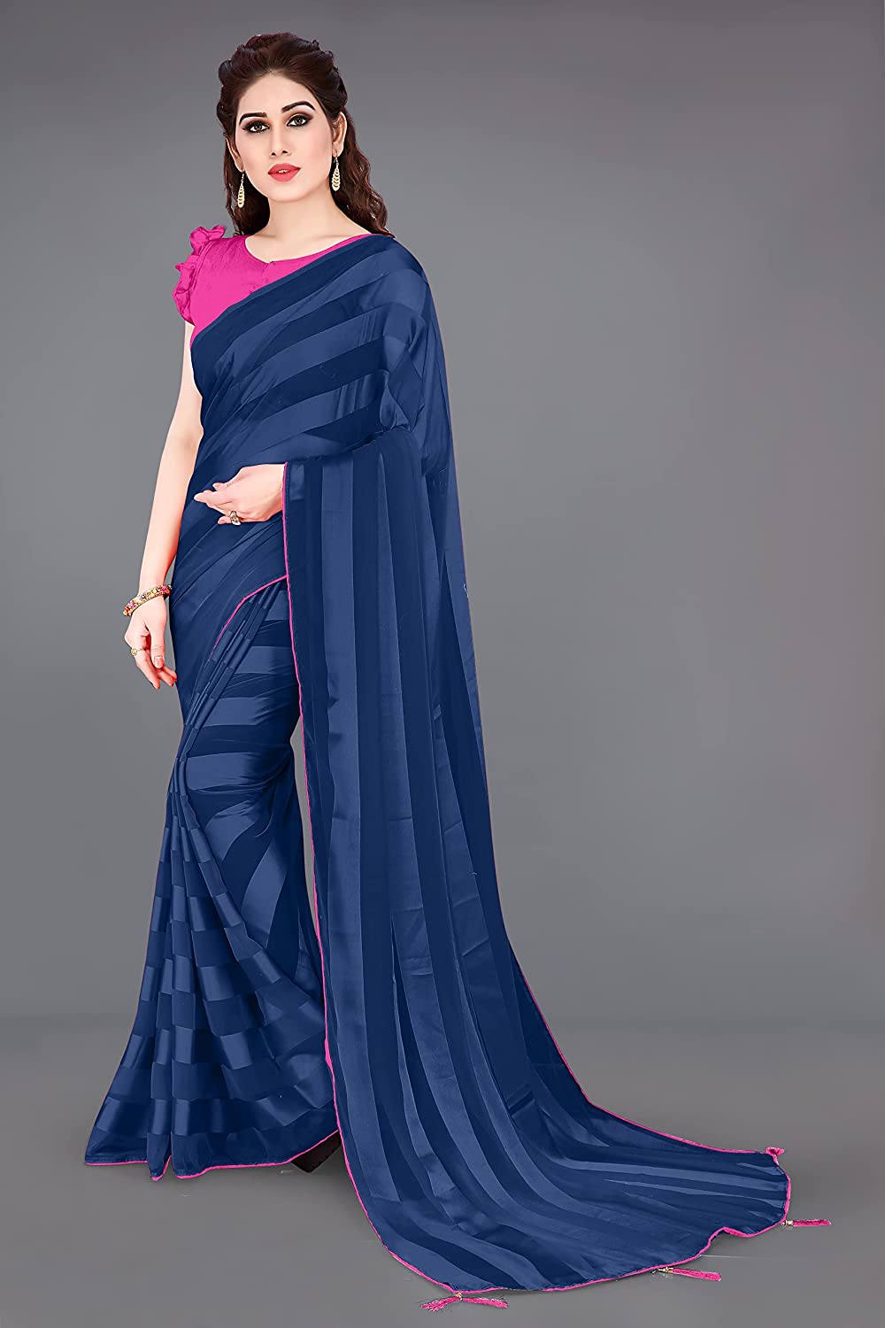 Navy blue georgette saree with shiny satin stripes, contrast pink lace border, and pallu tassels