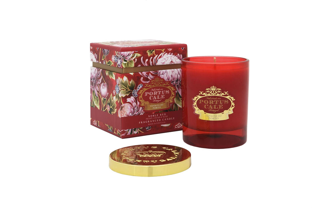 A luxurious Portus Cale glass candle in deep ruby red with gold accents and a botanical floral print.