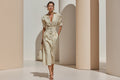 Model wearing a white and brown striped button-down midi dress with high waist and puffed sleeves.
