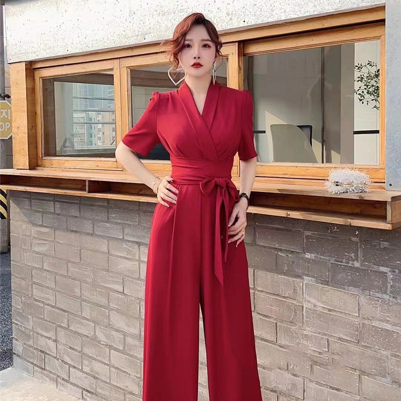 Elegant high-waist wide-leg jumpsuit in solid red and purple with V-neck and tie waist