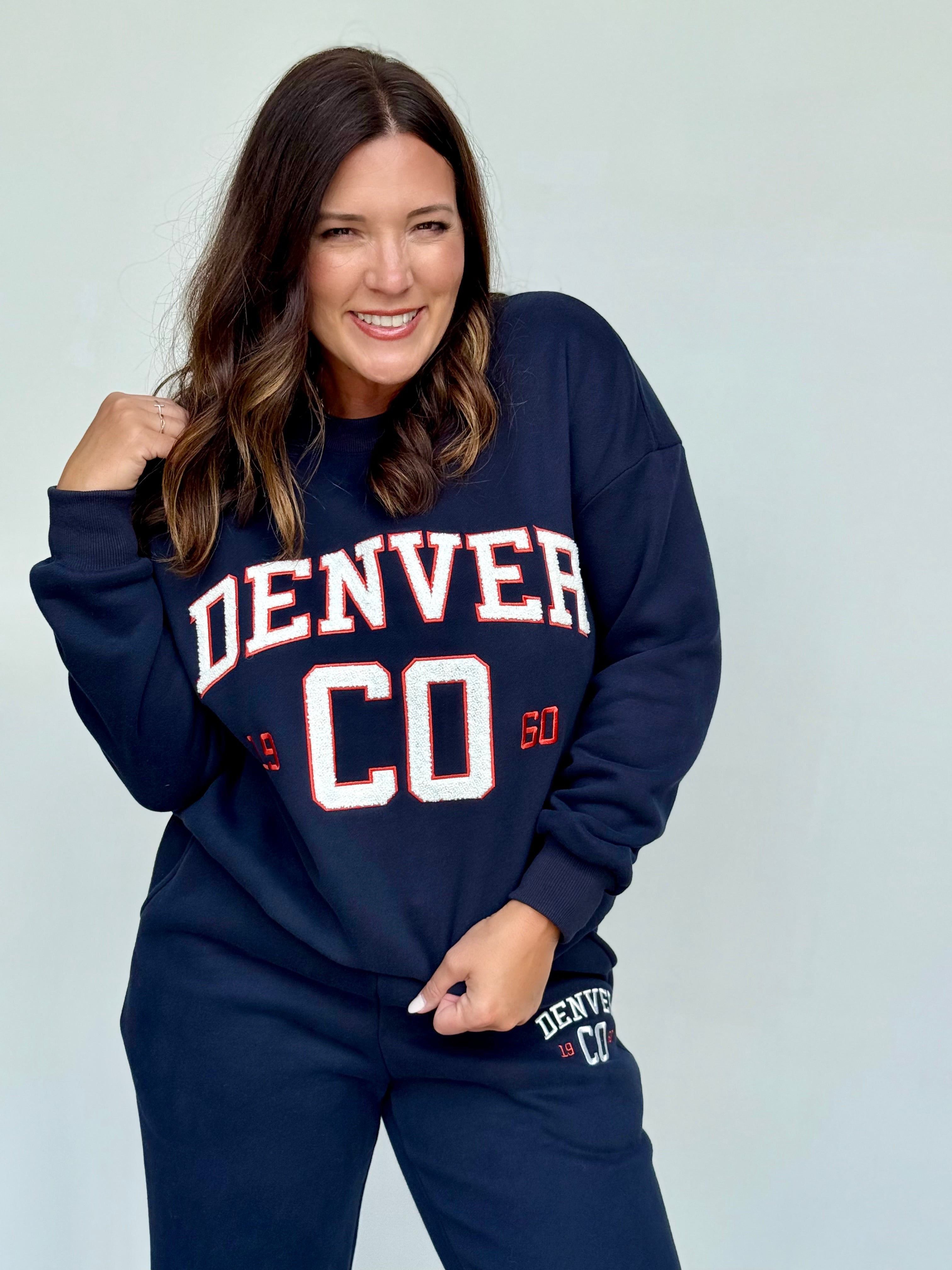 Navy blue crewneck sweatshirt with Denver chenille lettering in white and red.