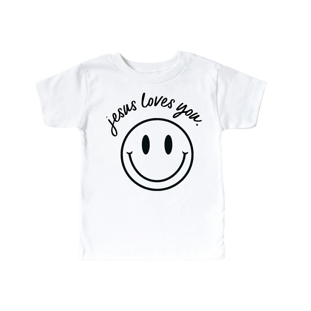 Jesus Loves You Smiley graphic baby tee for kids, available in white, black, grey, and cream.