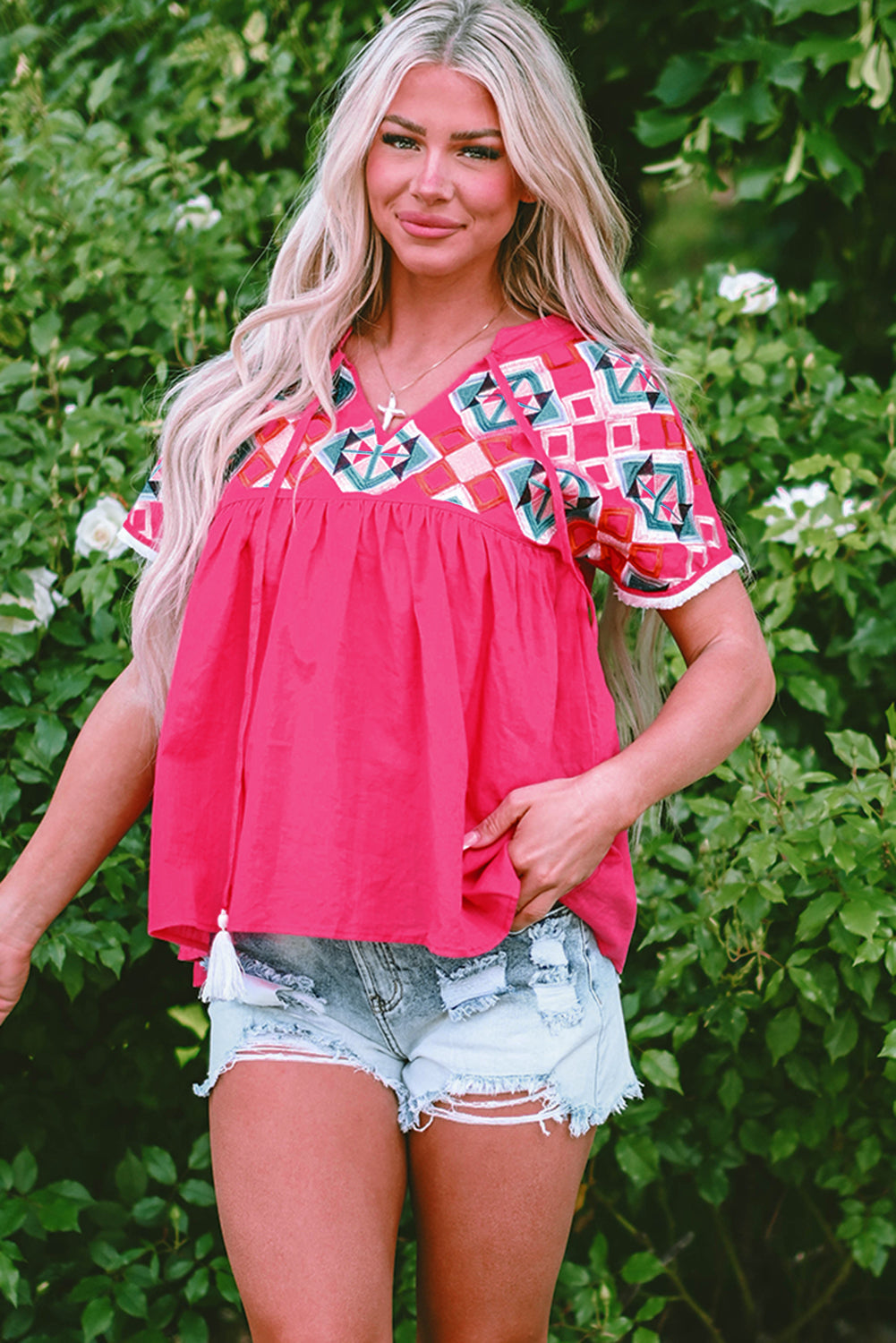 Close up of Zayla Embroidered Tassel Tie V Neck Blouse featuring geometric embroidery and tassel ties.