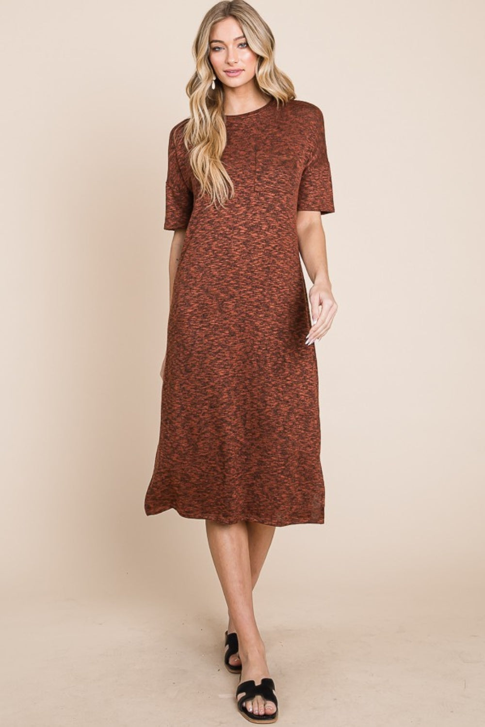 Minimalist knit midi dress with round neck and side slit, available in black and rust