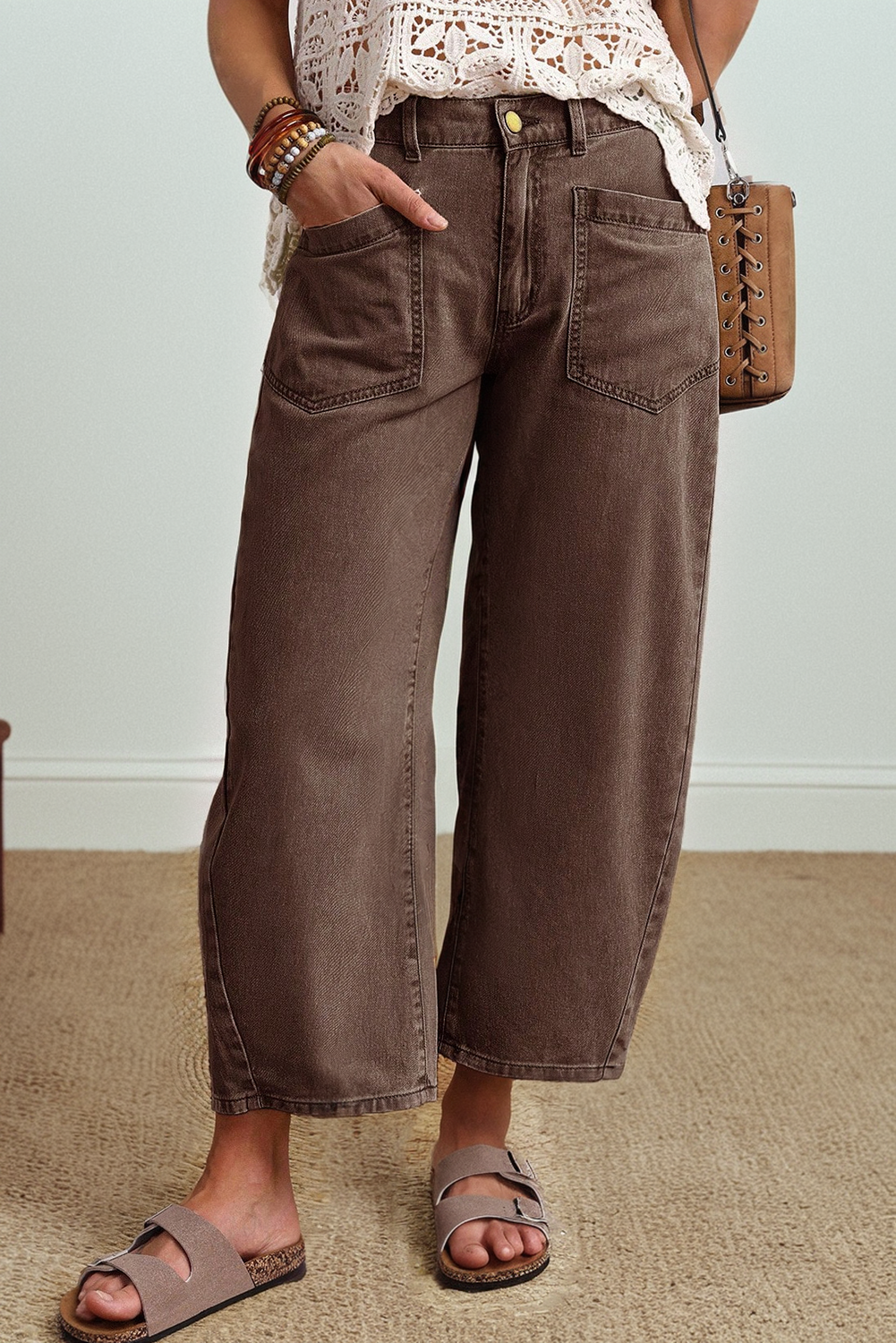 Model wearing brown Rhea ankle length barrel jeans with square back pockets