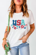 A woman wearing a white short sleeve t-shirt with a colorful USA retro graphic print on the front.