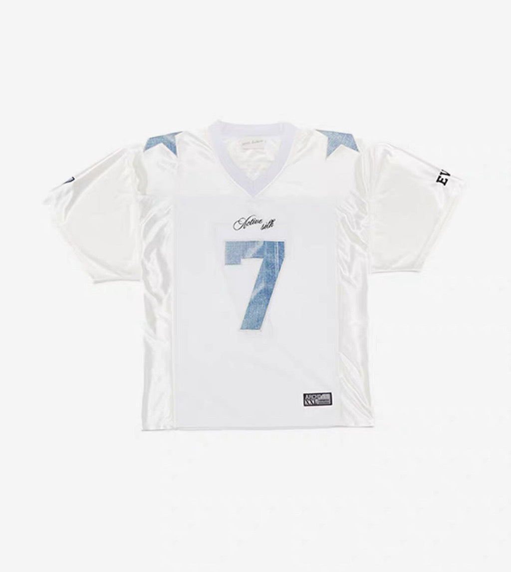 Women's Harajuku style white short sleeve digital mesh t-shirt with light blue number 7 and star print, shown on a flat lay and worn by a model outdoors.