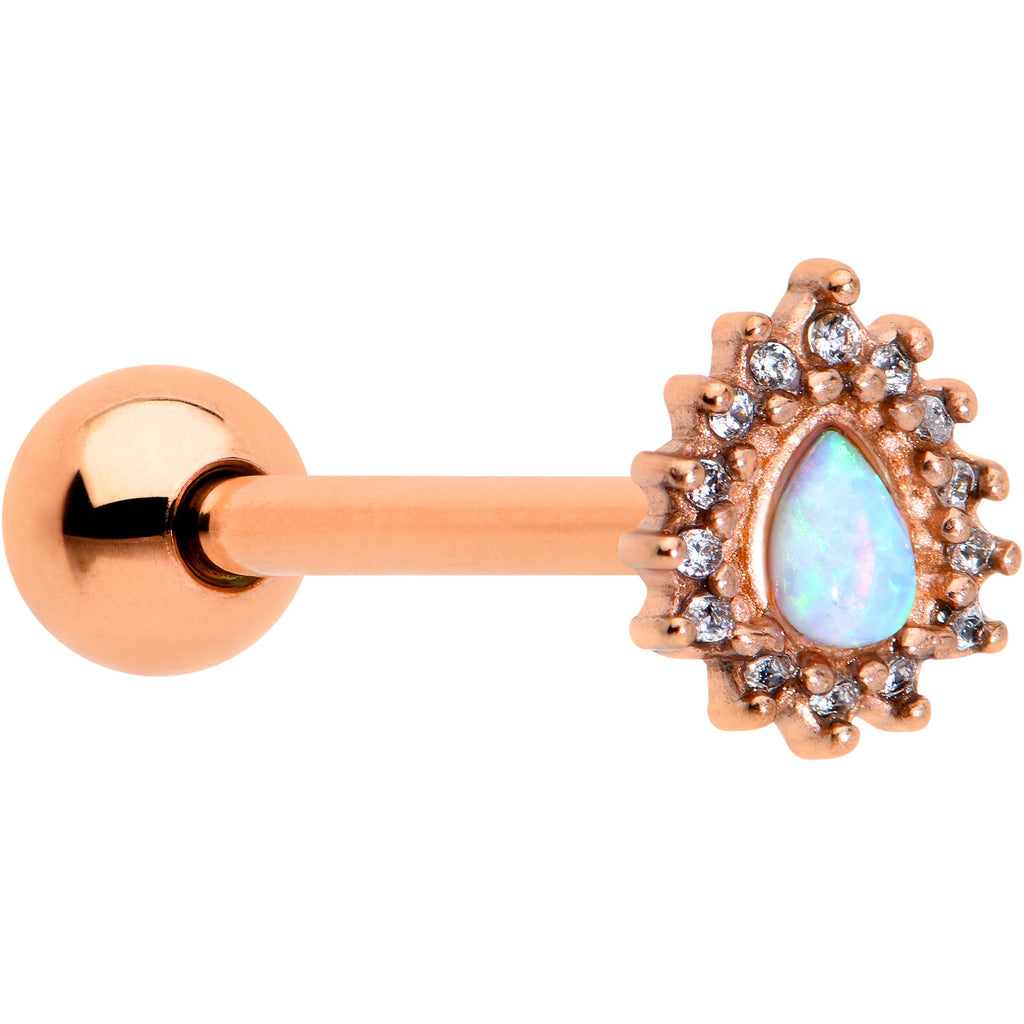 Close up of a 14 gauge tongue ring with a rose gold tone barbell and a drop-shaped white synthetic opal charm surrounded by clear cubic zirconia gems.