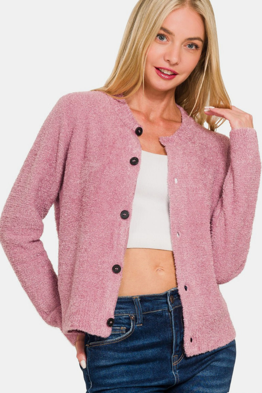 Model wearing a soft pink long sleeve button-down fuzzy knit cardigan