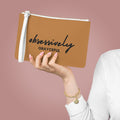 Minimalist vegan leather clutch bag in tan with wristlet loop handle and zip closure