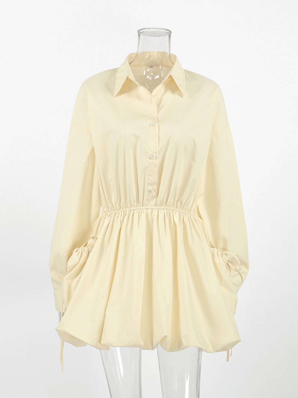 Light yellow blouse on a mannequin against a white background