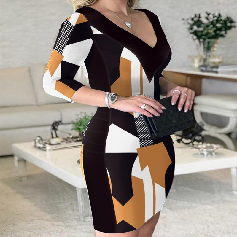 A modern V-neck A-line dress featuring a geometric print in black, white, and ochre.