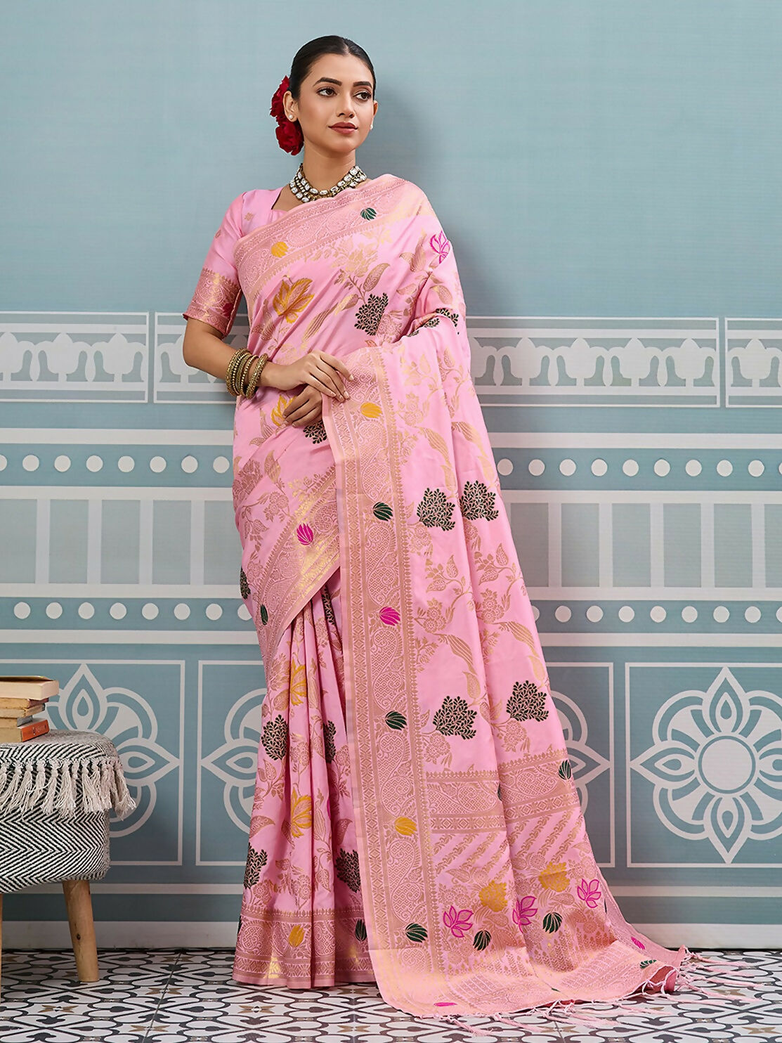 A luxurious light pink silk saree with a matching blouse piece