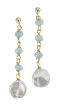 A pair of gold-tone hanging earrings featuring blue faceted aquamarine stones and large white freshwater pearls.
