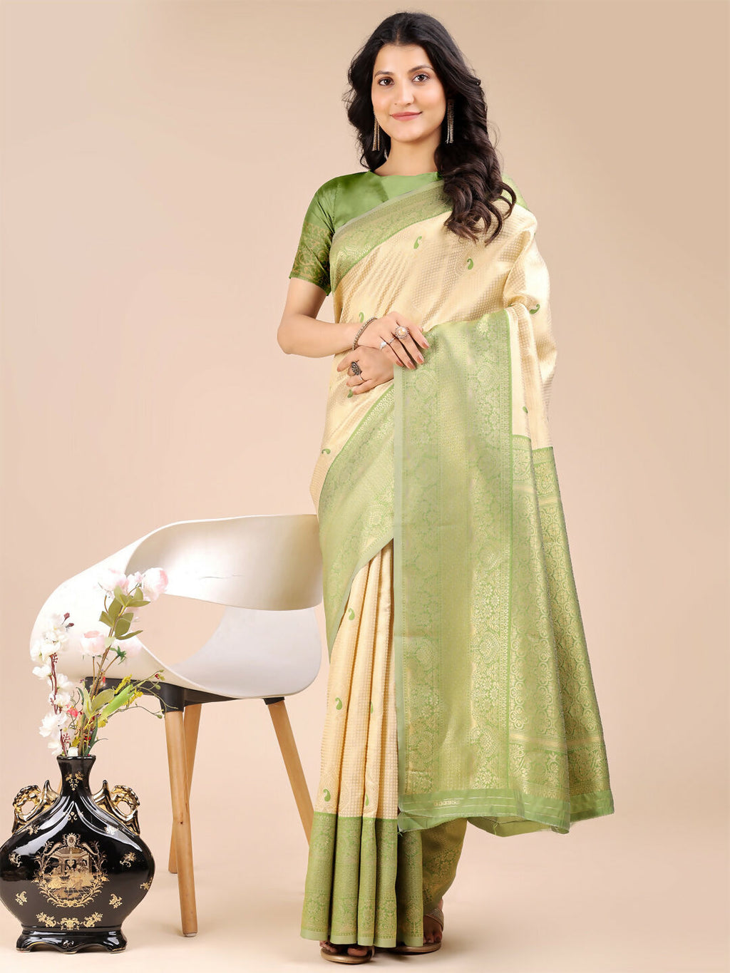 Woman wearing a Cream and Light Green Banarasi silk saree with intricate traditional patterns