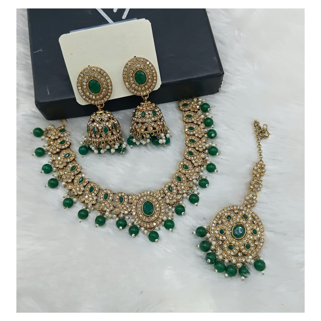 Exquisite green stone work necklace set featuring traditional craftsmanship and matching drop earrings.