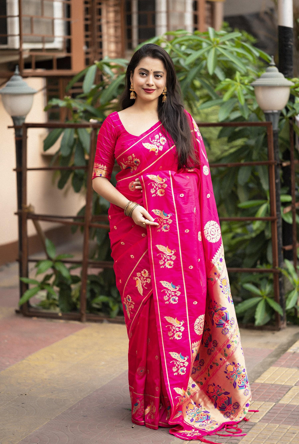 Vibrant rani pink pure silk saree with gold zari woven design and tassel pallu