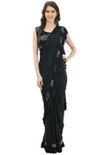 Model wearing a black ruffled ready-to-wear saree with a sequence-embroidered blouse