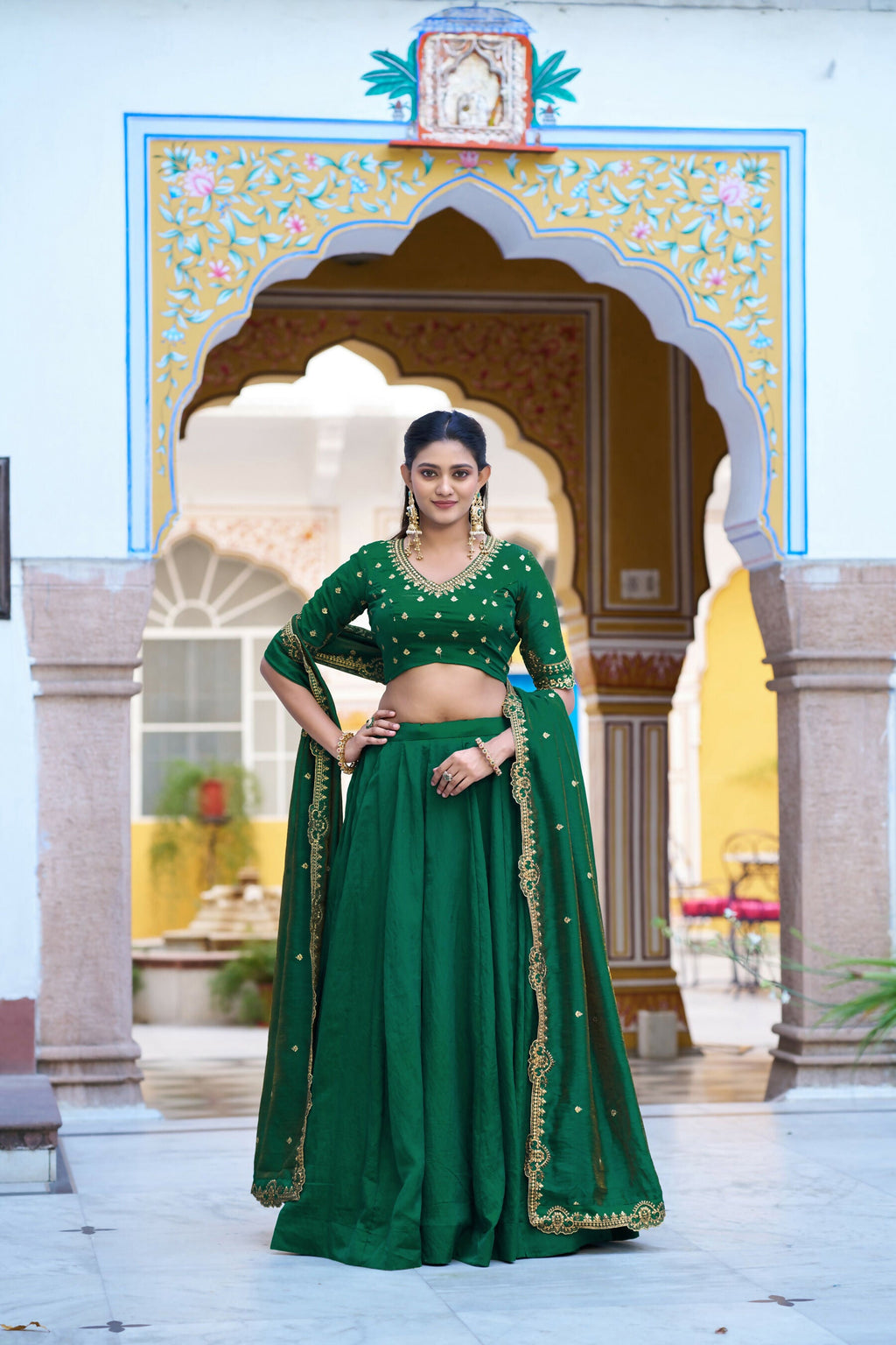 Green NC Silk lehenga set featuring embroidered choli and matching dupatta.