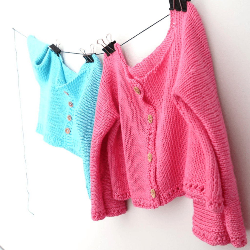 Close up of soft cotton-blend yarn and a hand-knit baby cardigan from the Cotton Candy Knitting Kit