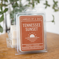 A pack of Tennessee Sunset wax melts in clear plastic packaging with a rustic orange label on a wooden table.