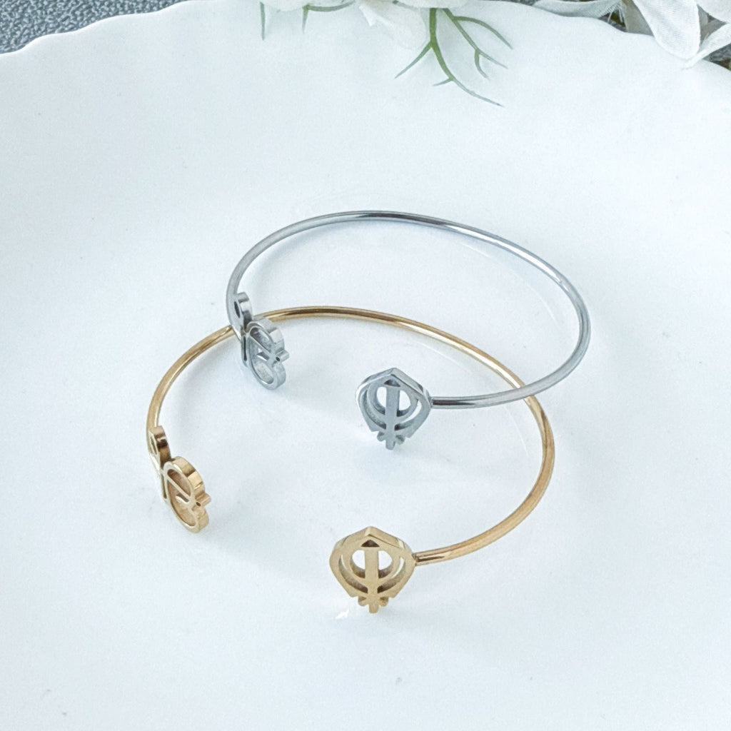 Sleek 18K gold open-cuff bangle with a minimalist, high-polish finish.