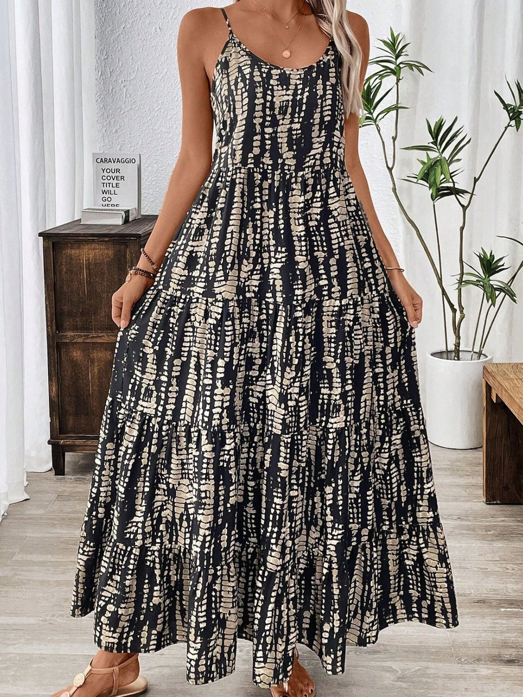 Woman wearing a black and beige abstract print bohemian maxi dress