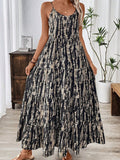 Woman wearing a black and beige abstract print bohemian maxi dress