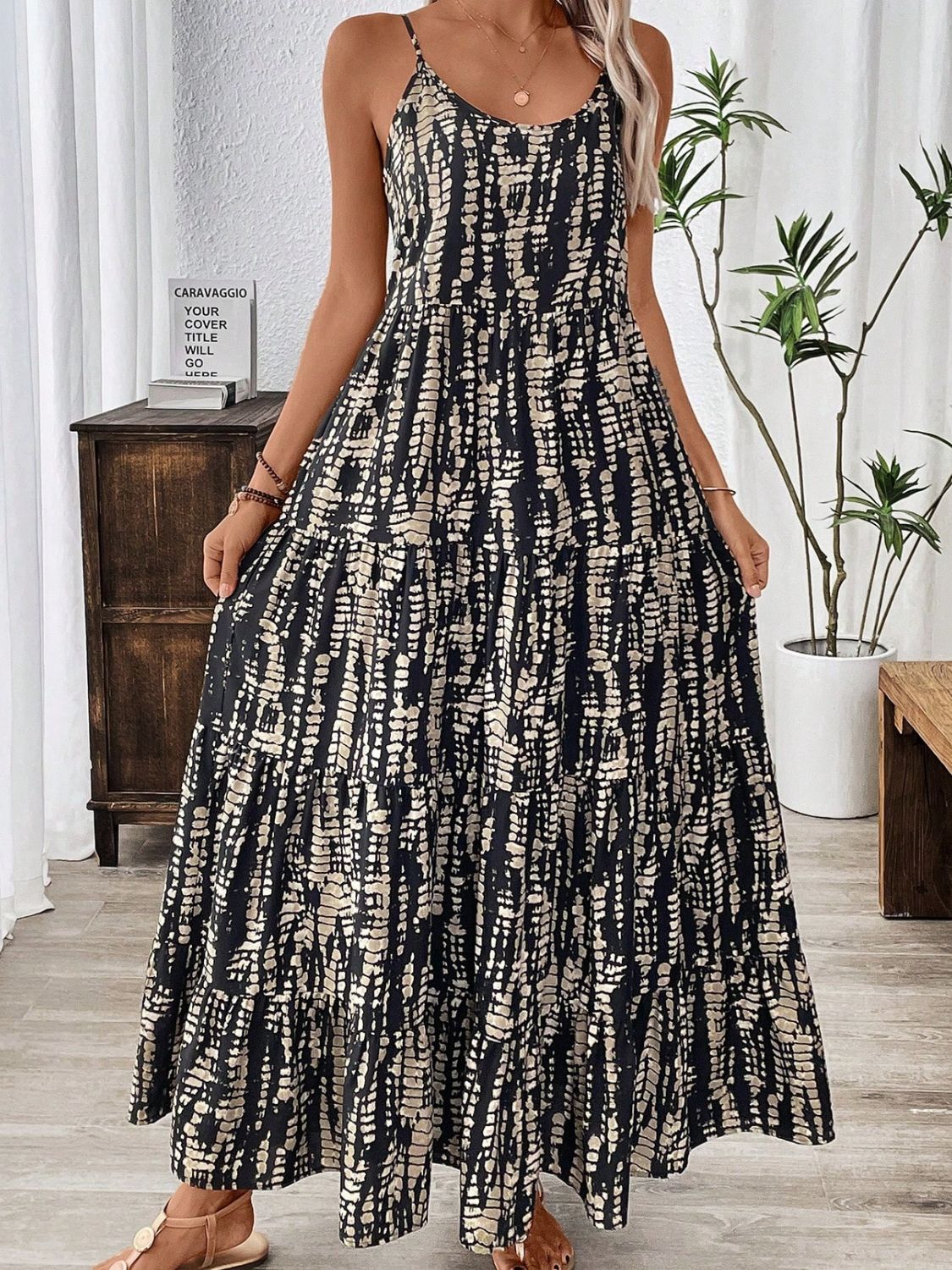 Woman wearing a black and beige abstract print bohemian maxi dress