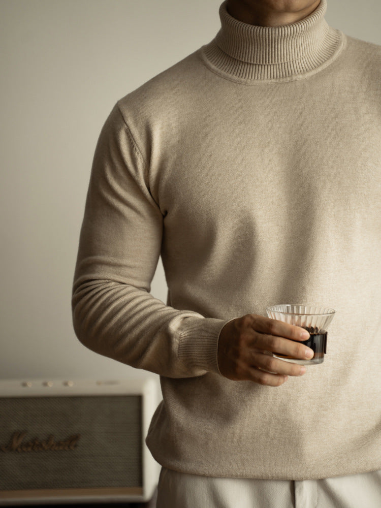 Men wearing a charcoal grey turtleneck knit sweater with a minimalist, regular fit silhouette.