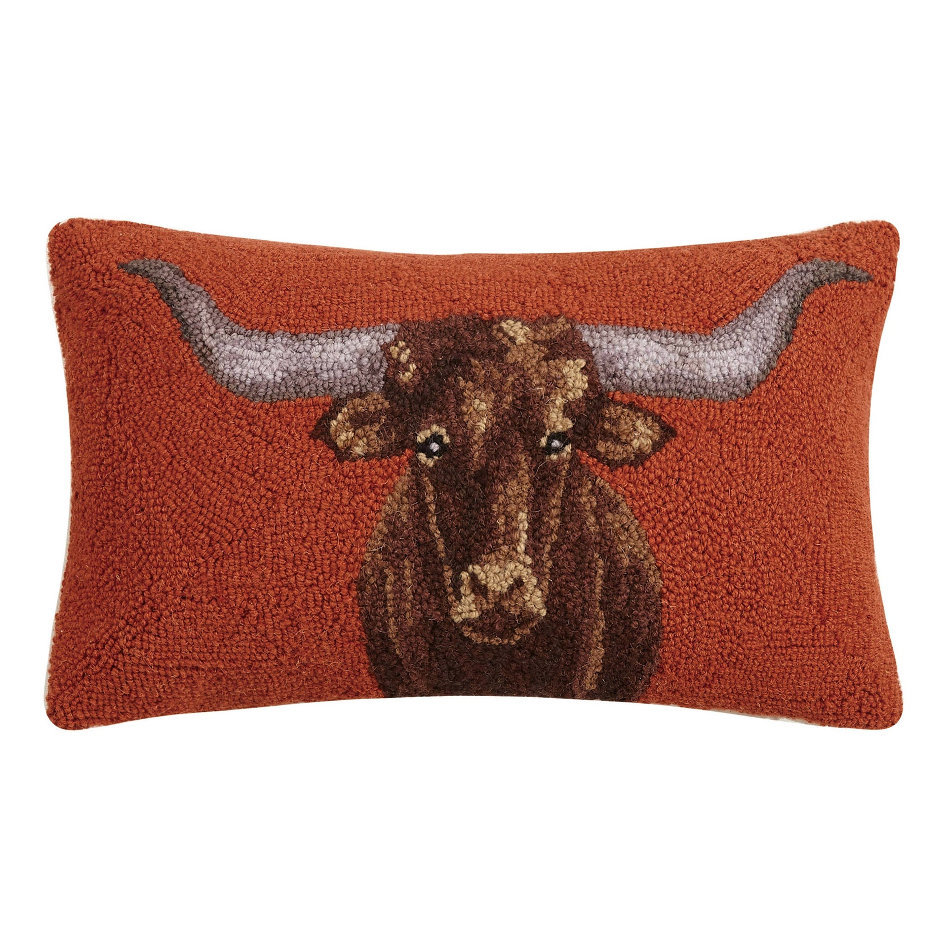 Rectangular 20x12 longhorn hooked wool lumbar pillow with rust background and velvet backing on a rustic living room sofa.