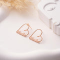 Custom-made heart-shaped stud earrings featuring a script name in a polished gold-tone finish.