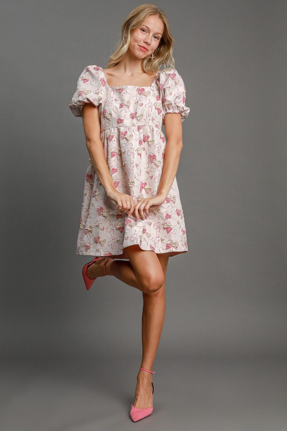 Model wearing an off-white heart jacquard square neck mini dress with puff sleeves