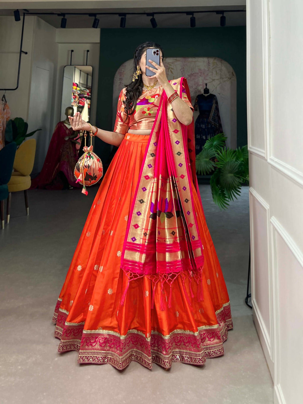 A woman wearing a traditional red Jacquard Silk Paithani lehenga choli with intricate cultural motifs.