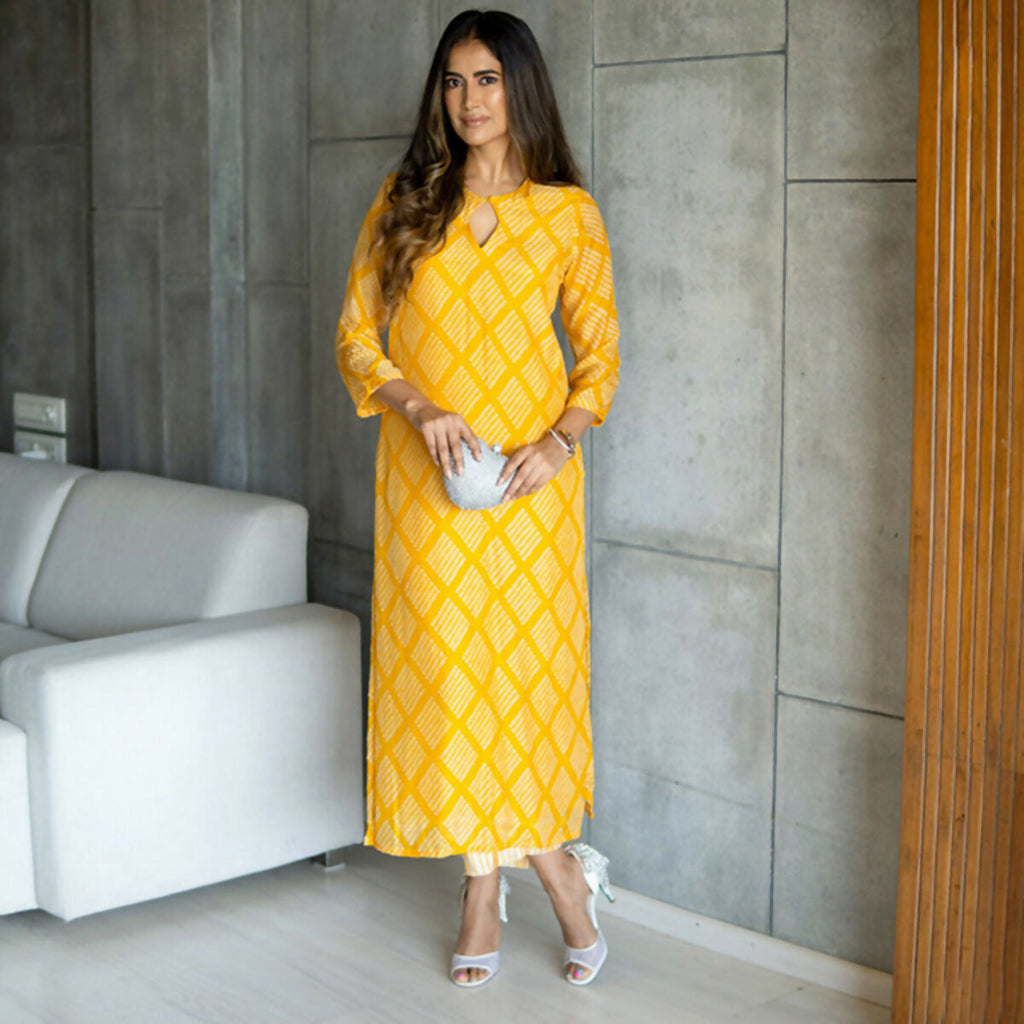 Women wearing a Yellow Pure Muslin straight kurta and pant set with heavy digital print