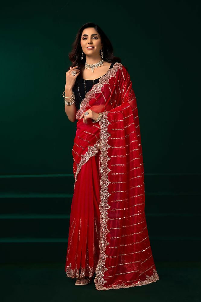 Red net party wear saree featuring a black velvet blouse for a luxurious look.