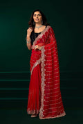 Red net party wear saree featuring a black velvet blouse for a luxurious look.