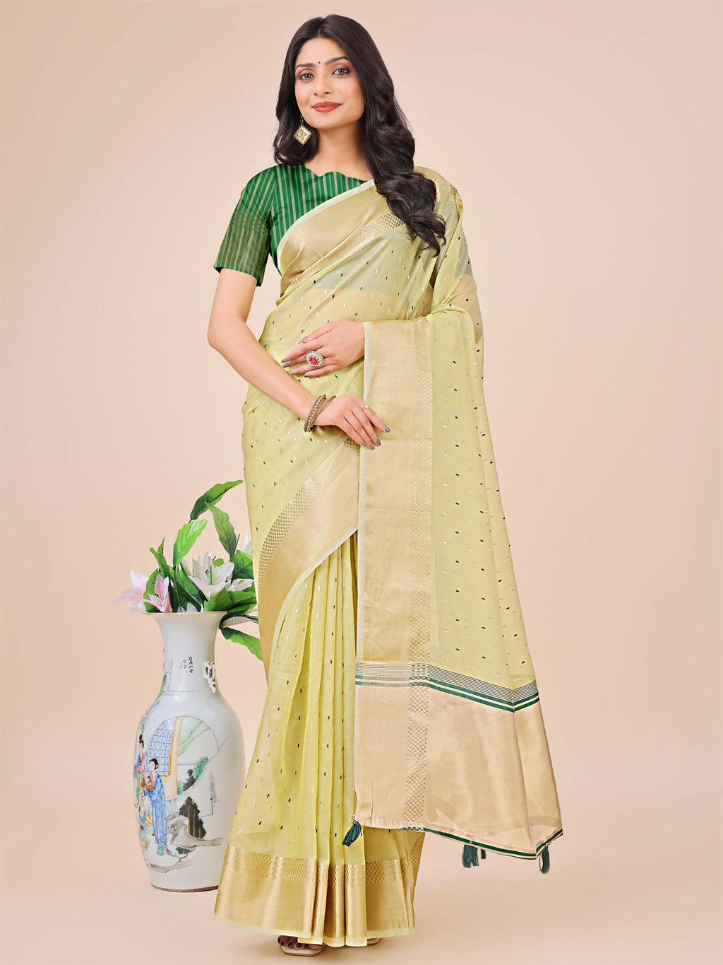 Light green organza saree with matching blouse fabric for an elegant look.