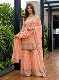 Vibrant orange georgette kurti featuring delicate embroidery, styled with a matching sharara set.