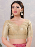 Woman wearing a sophisticated light-gold jacquard stitched blouse for festive ethnic styling.