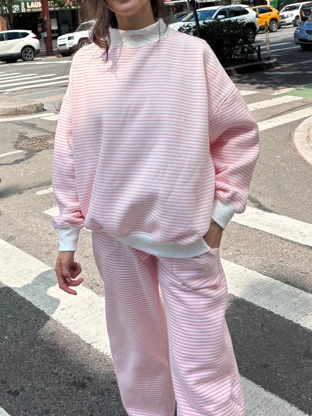 Relaxed fit light pink and white big striped sweatpants for men and women.
