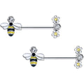 Close-up of a pair of 14 gauge yellow and clear CZ gem flower and bee nipple rings on a white background.