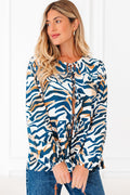 Zebra print blouse featuring puff sleeves and a front tie detail
