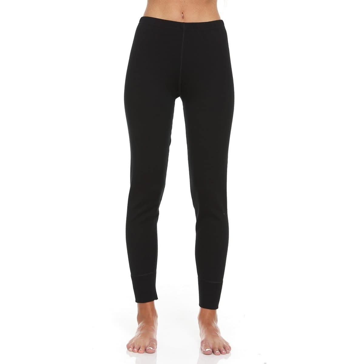 Women wearing black 100% Merino wool thermal base layer pants in a sporty, tapered fit.
