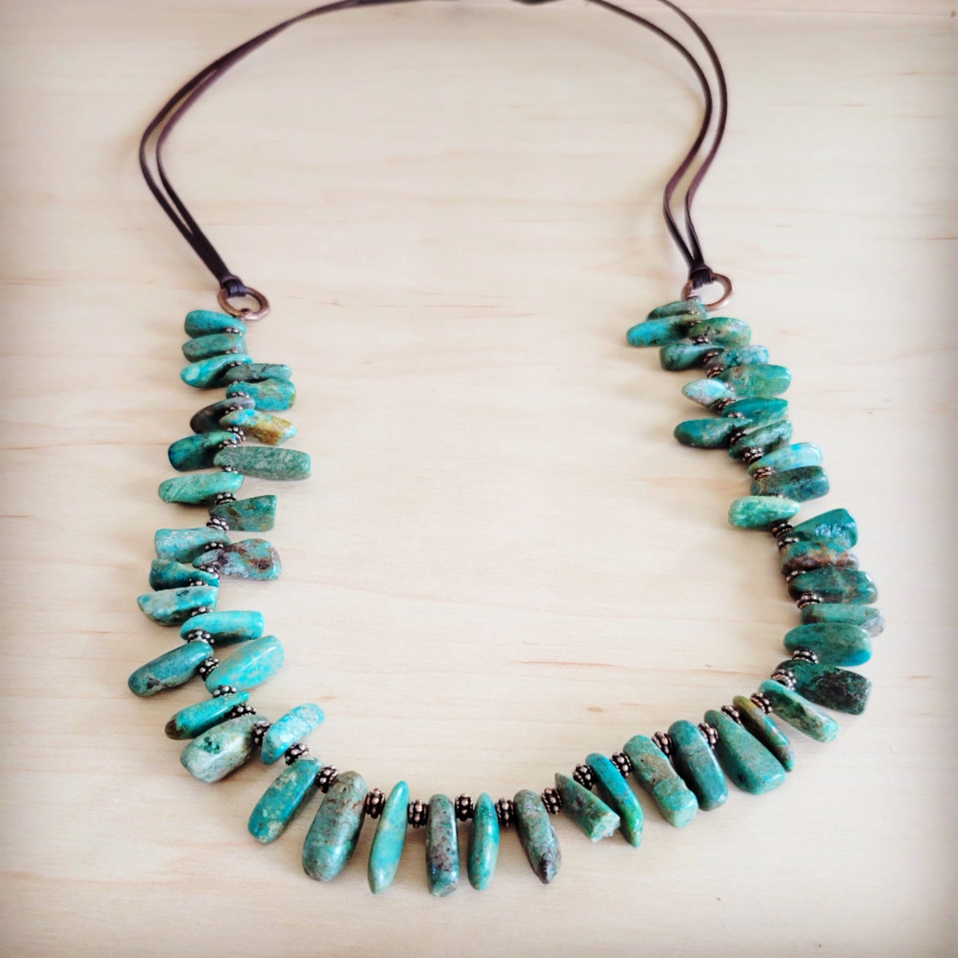 A handmade stacked turquoise stone necklace featuring genuine brown leather ties and natural Oregon turquoise beads.