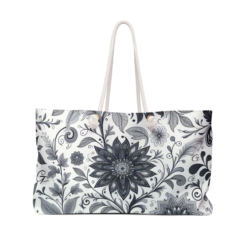 Spacious floral print weekender tote bag with rope handles for travel and beach use.